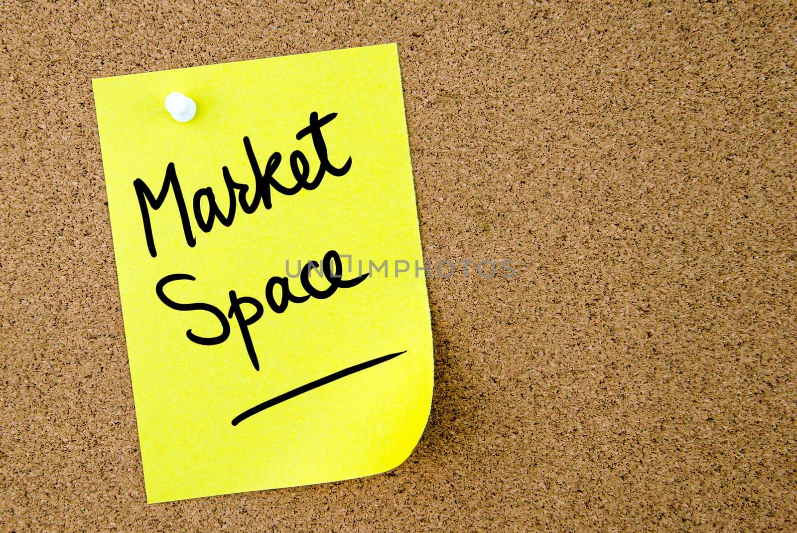 Market Space text written on yellow paper note pinned on cork board with white thumbtack. Business concept image with copy space available