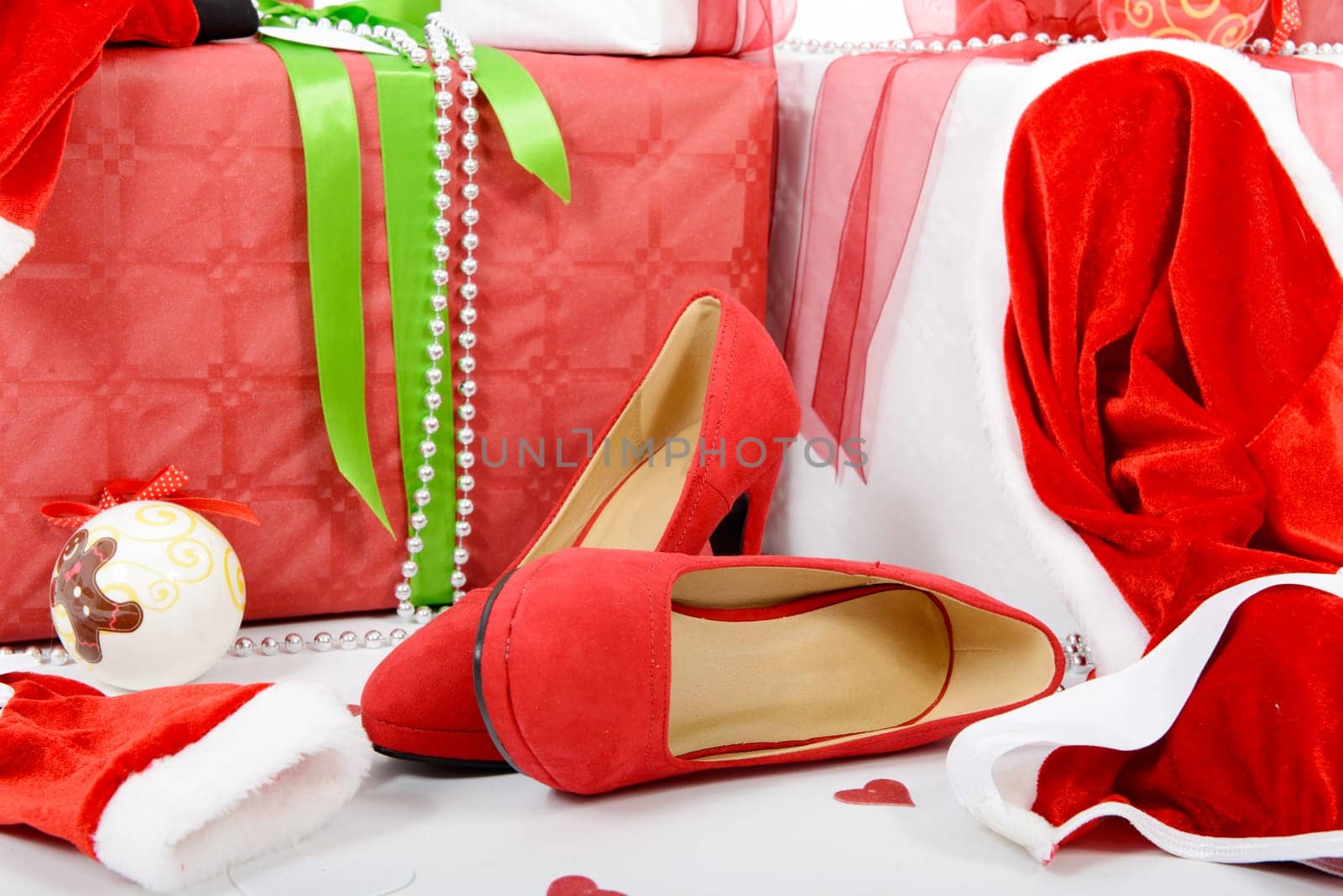 the red and white Christmas gift boxes with woman shoes