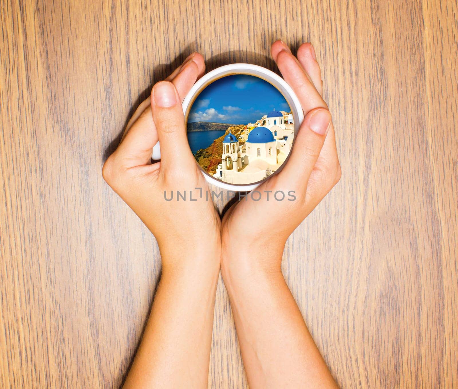 Woman holding cup with dream about vacation against wooden table. Top view. Conceptual photo