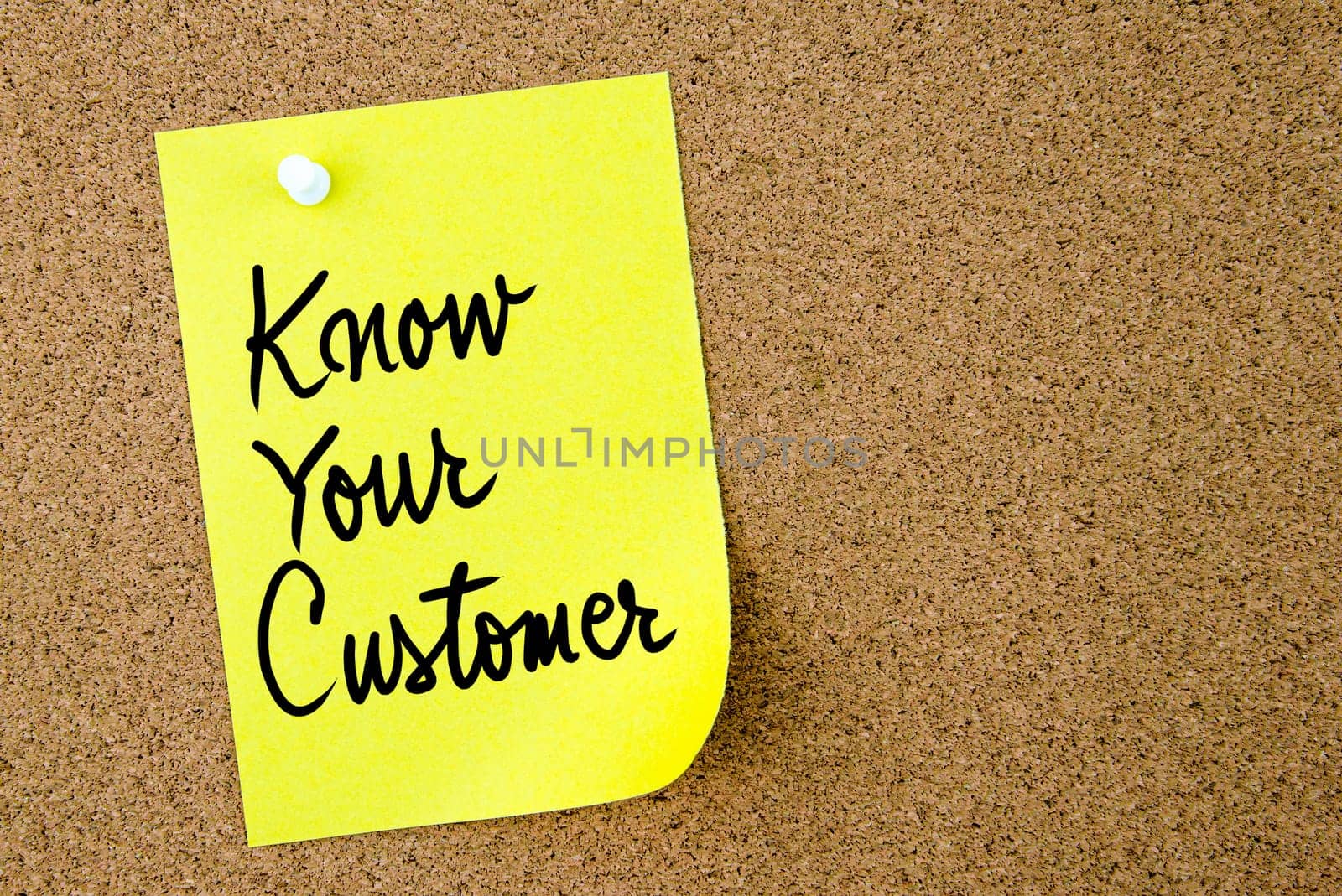 Know Your Customer text written on yellow paper note pinned on cork board with white thumbtack. Business concept image with copy space available