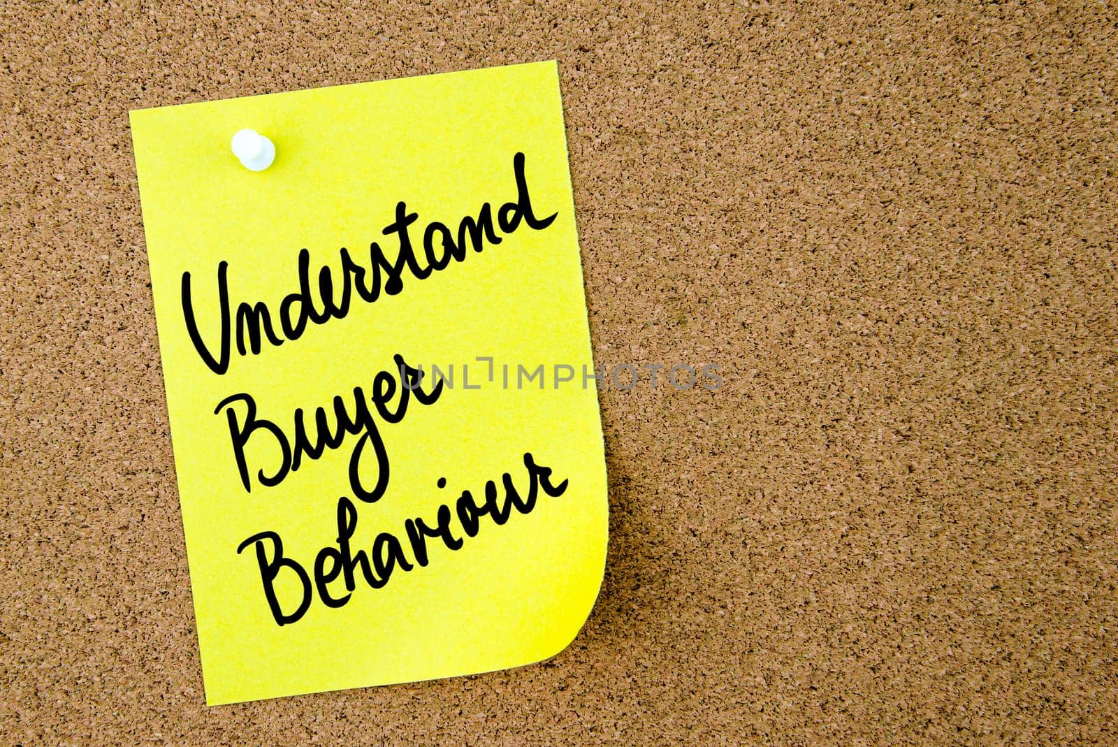 Understand Buyer Behaviour text written on yellow paper note pinned on cork board with white thumbtack. Business concept image with copy space available