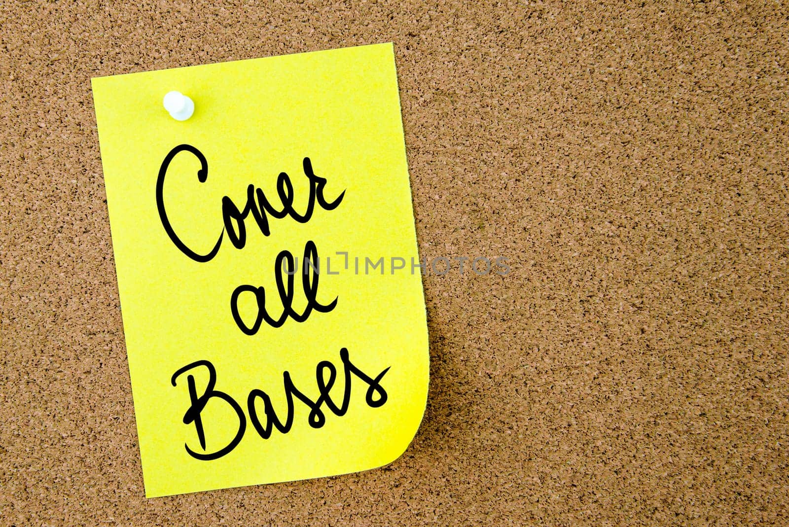 Cover All Bases text written on yellow paper note pinned on cork board with white thumbtack. Business concept image with copy space available
