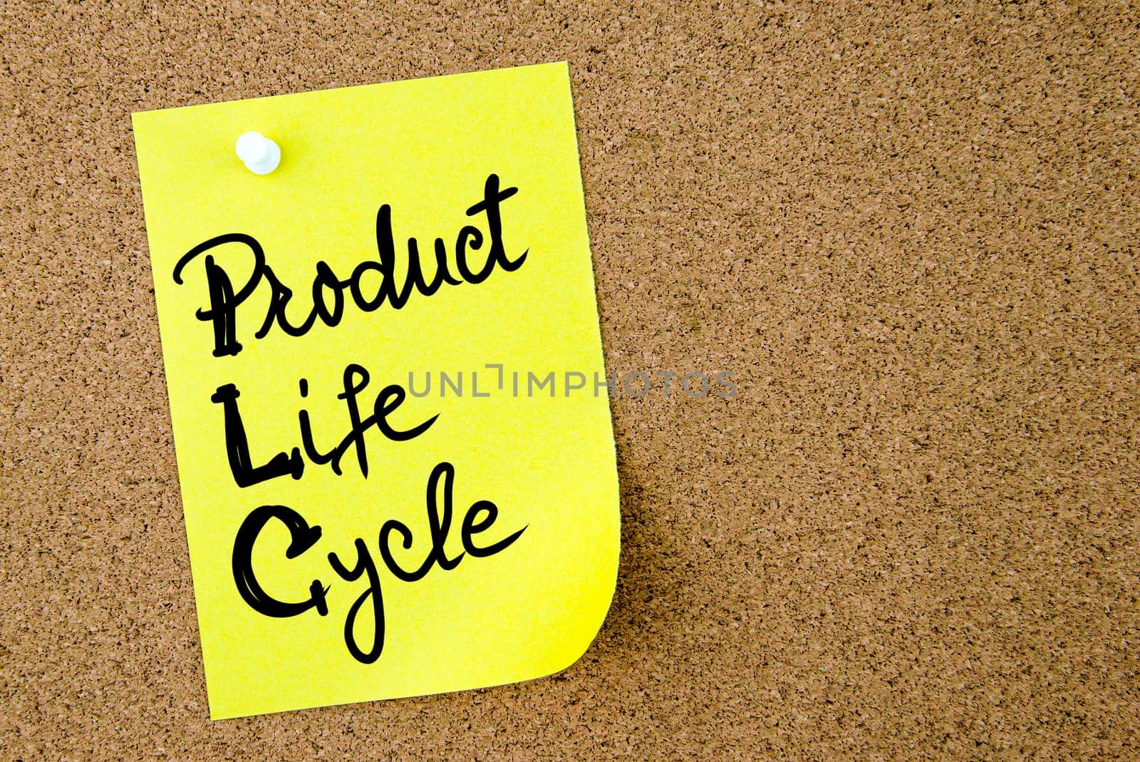 Product Life Cycle text written on yellow paper note pinned on cork board with white thumbtack. Business concept image with copy space available