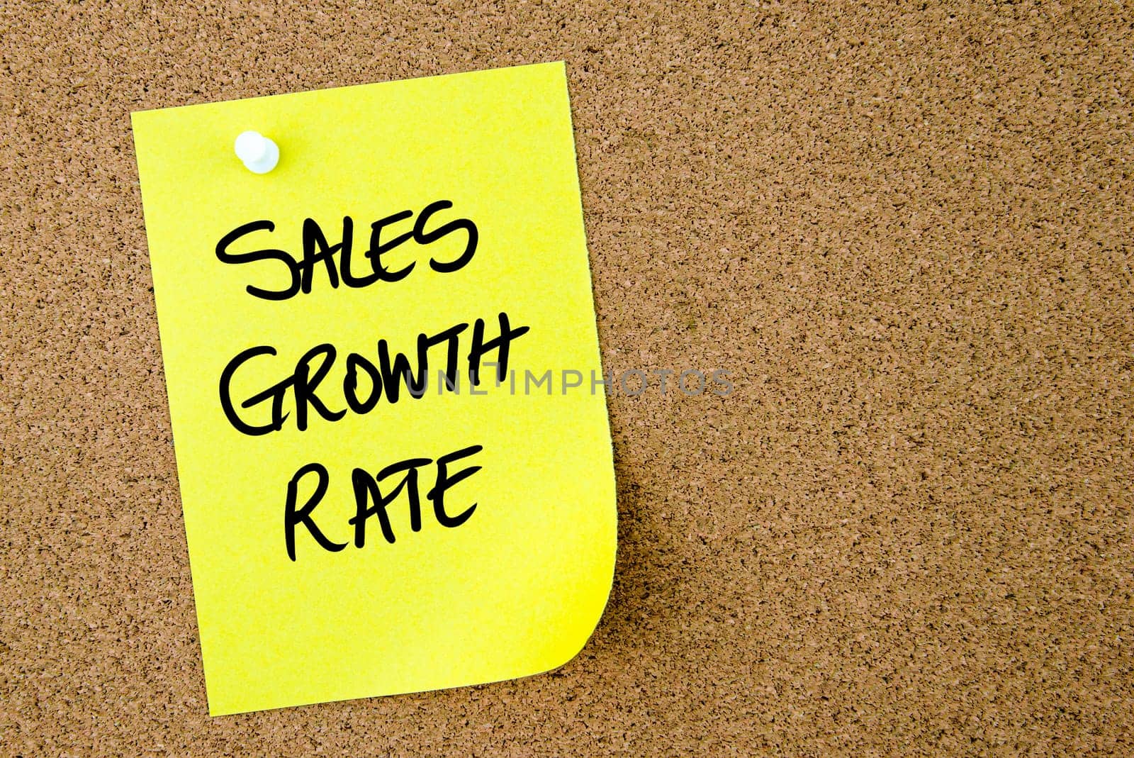 Sales Growth Rate text written on yellow paper note pinned on cork board with white thumbtack. Business concept image with copy space available