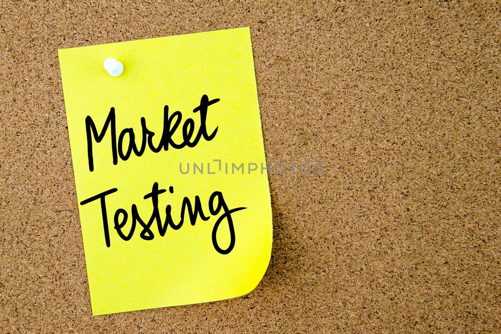 Market Testing text written on yellow paper note pinned on cork board with white thumbtack. Business concept image with copy space available