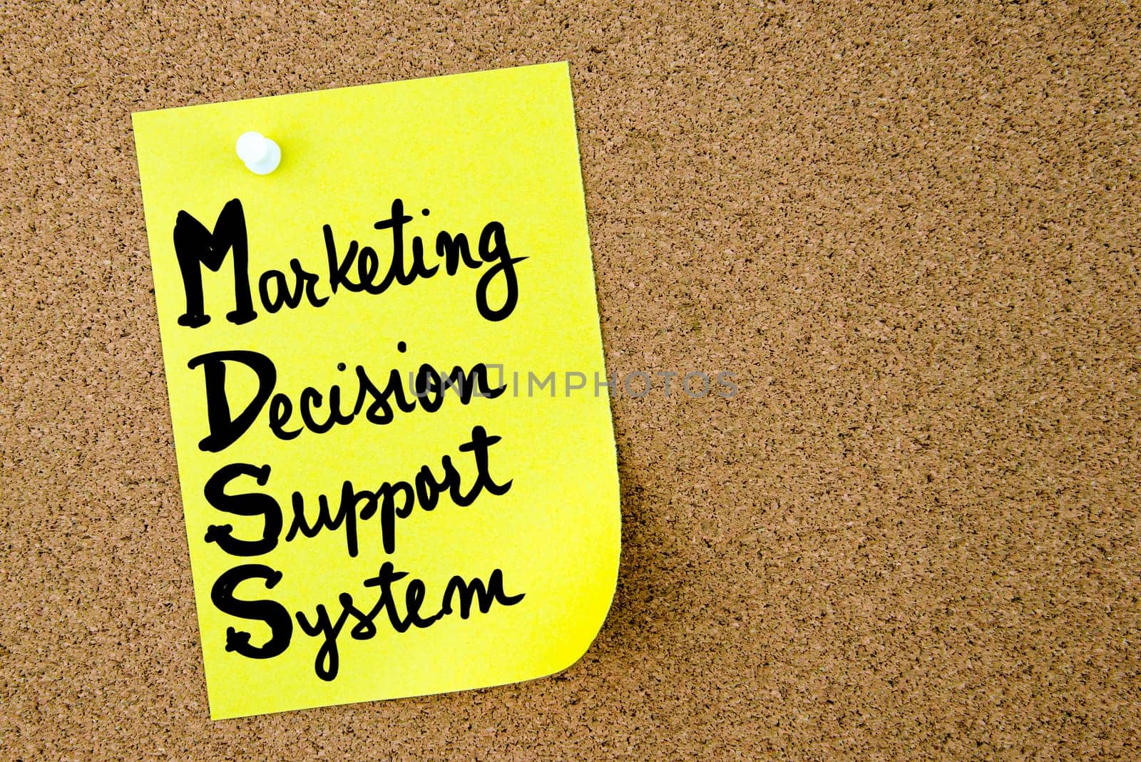 MDSS Marketing Decision Support System written on yellow paper note pinned on cork board with white thumbtack. Business concept image with copy space available