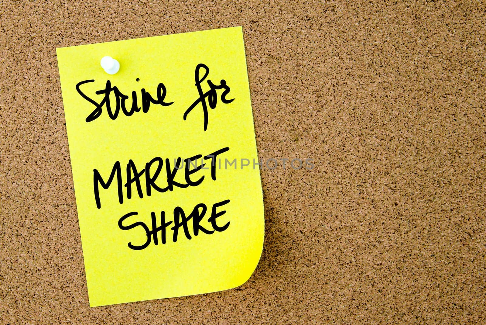 Strive For Market Share text written on yellow paper note pinned on cork board with white thumbtack. Business concept image with copy space available