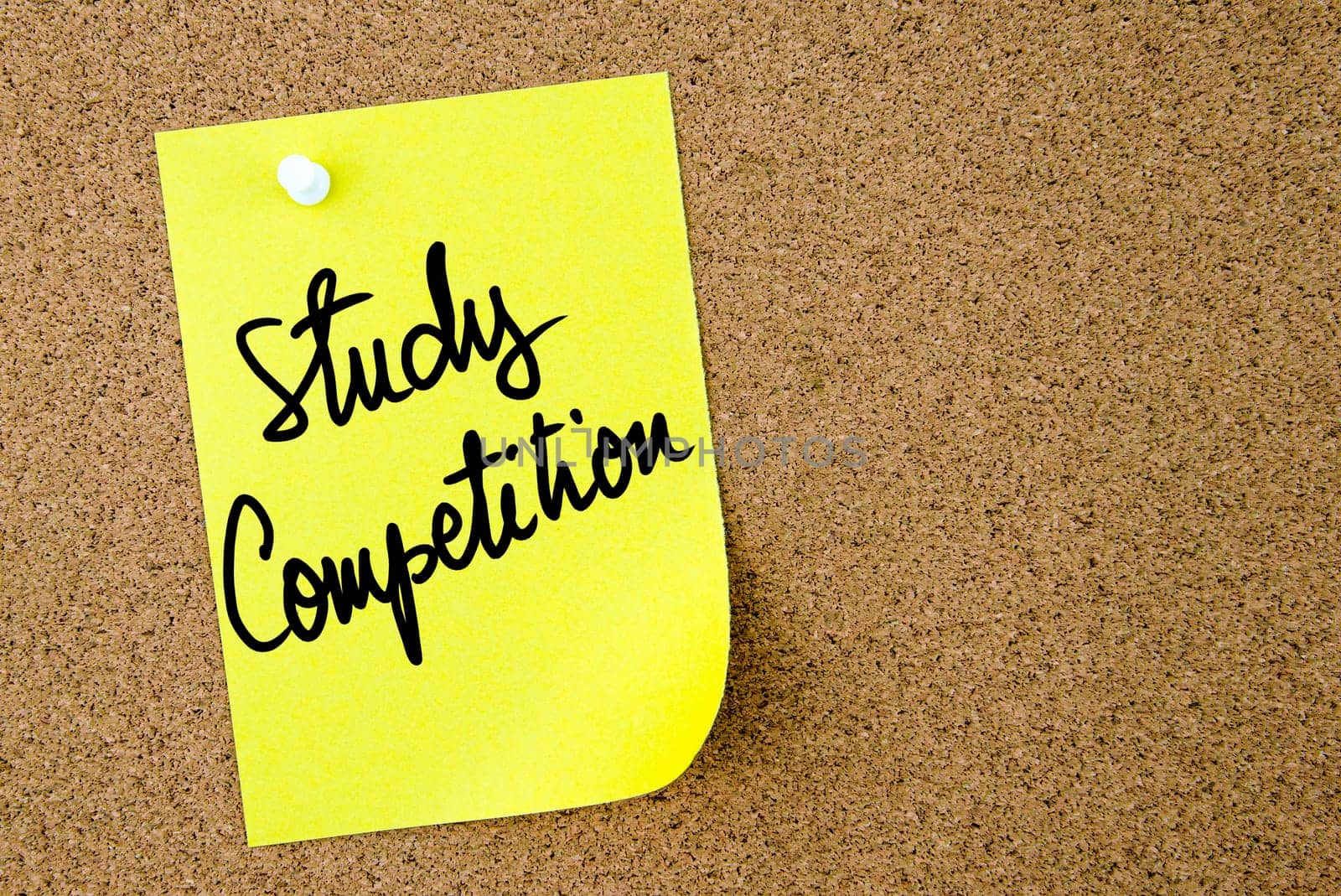 Study Competition text written on yellow paper note pinned on cork board with white thumbtack. Business concept image with copy space available