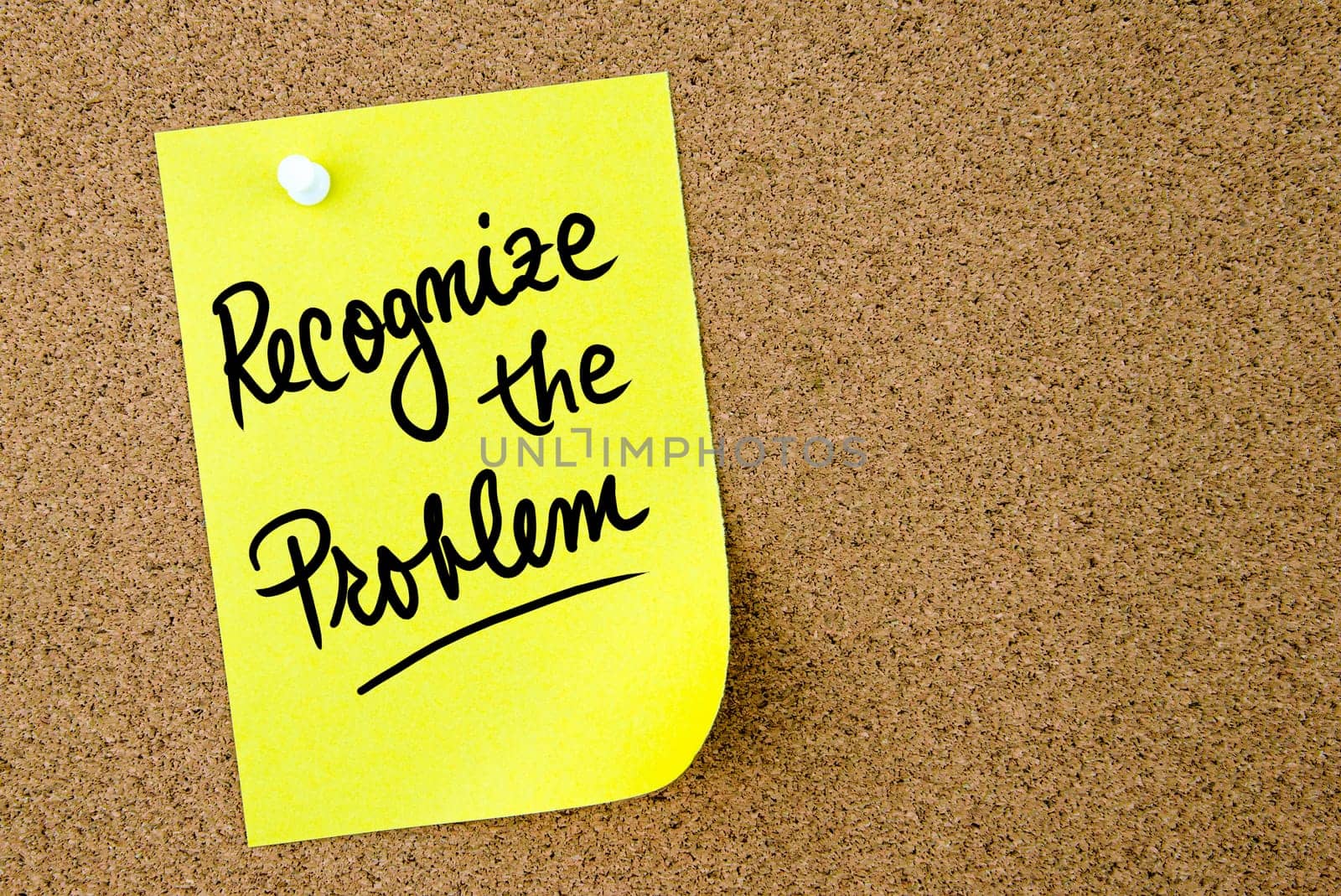 Recognize the problem text written on yellow paper note pinned on cork board with white thumbtack. Business concept image with copy space available