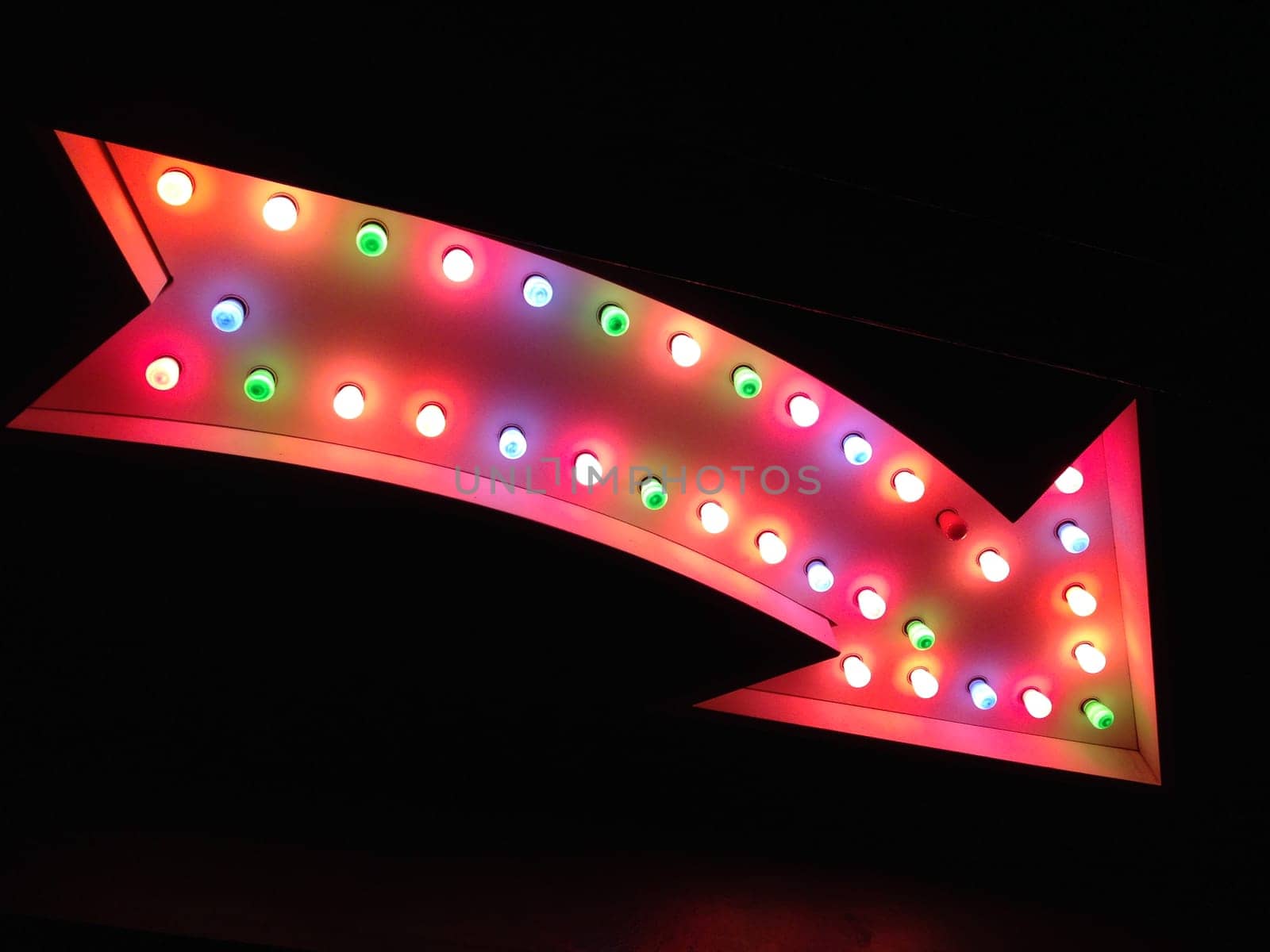 fairground carnival circus Las vegas style arrow pointing at night