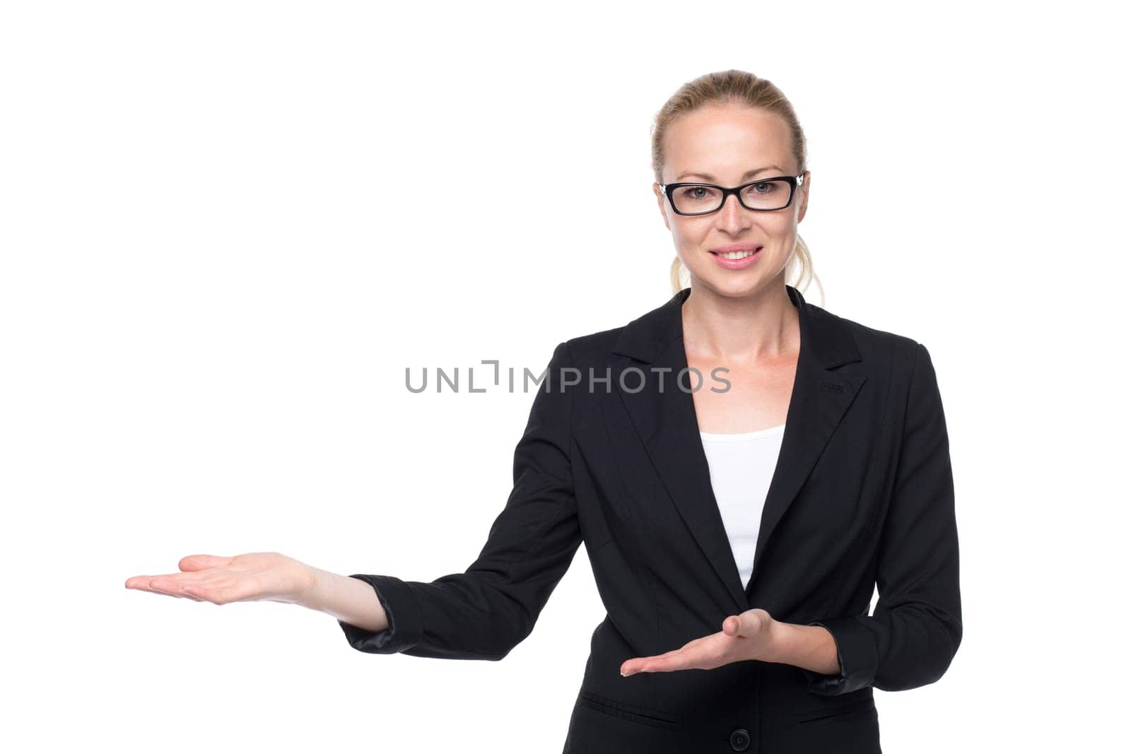 Beautiful young businesswoman smiling, holding open palm with empty copy space. Business woman showing hand sign to side, concept of advertisement product. White background.