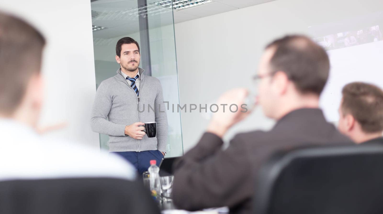 Relaxed cheerful team leader and business owner leading informal in-house business meeting. Business and entrepreneurship concept.