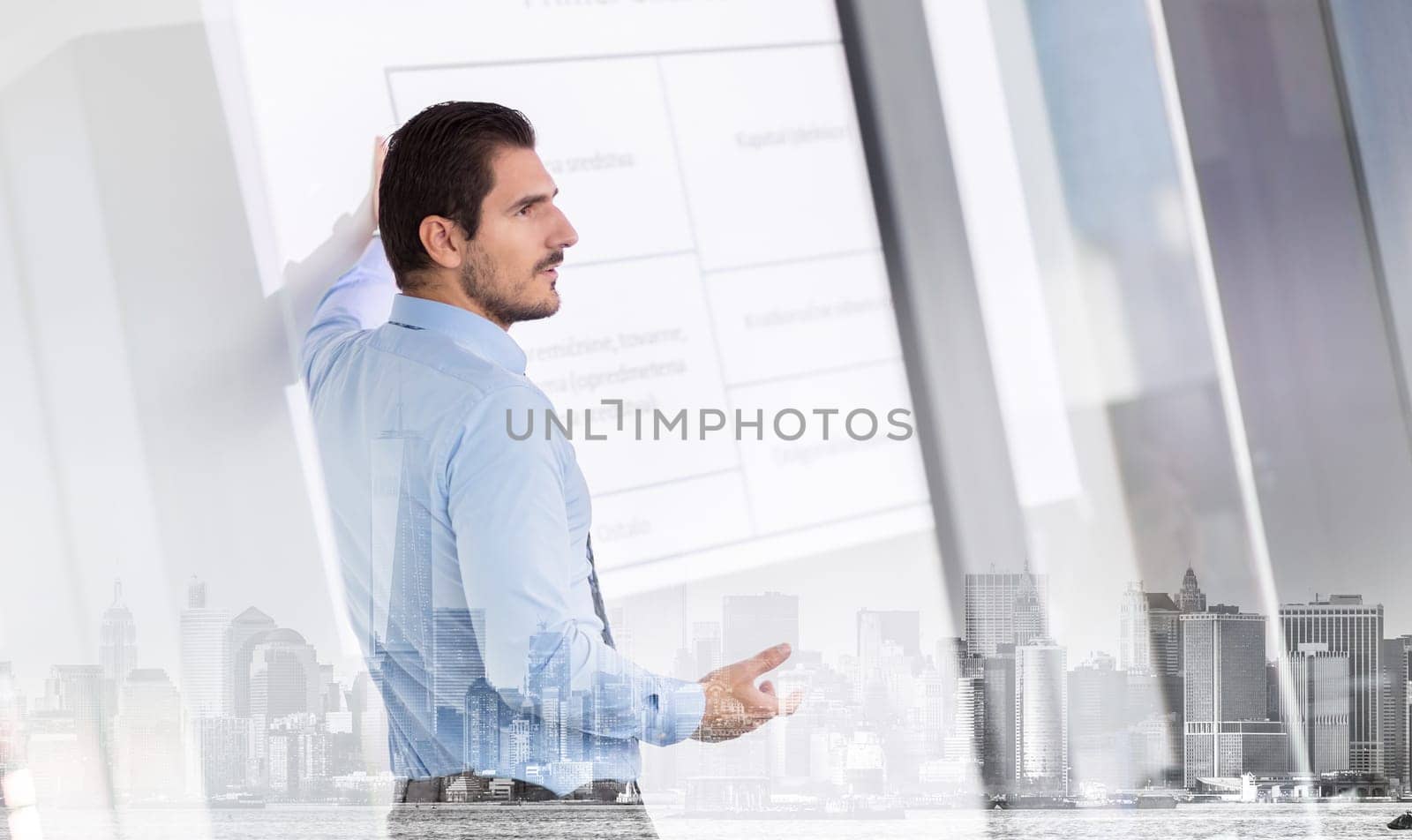Business man making a presentation in front of whiteboard. Business executive delivering a presentation to his colleagues during meeting or in-house business training.