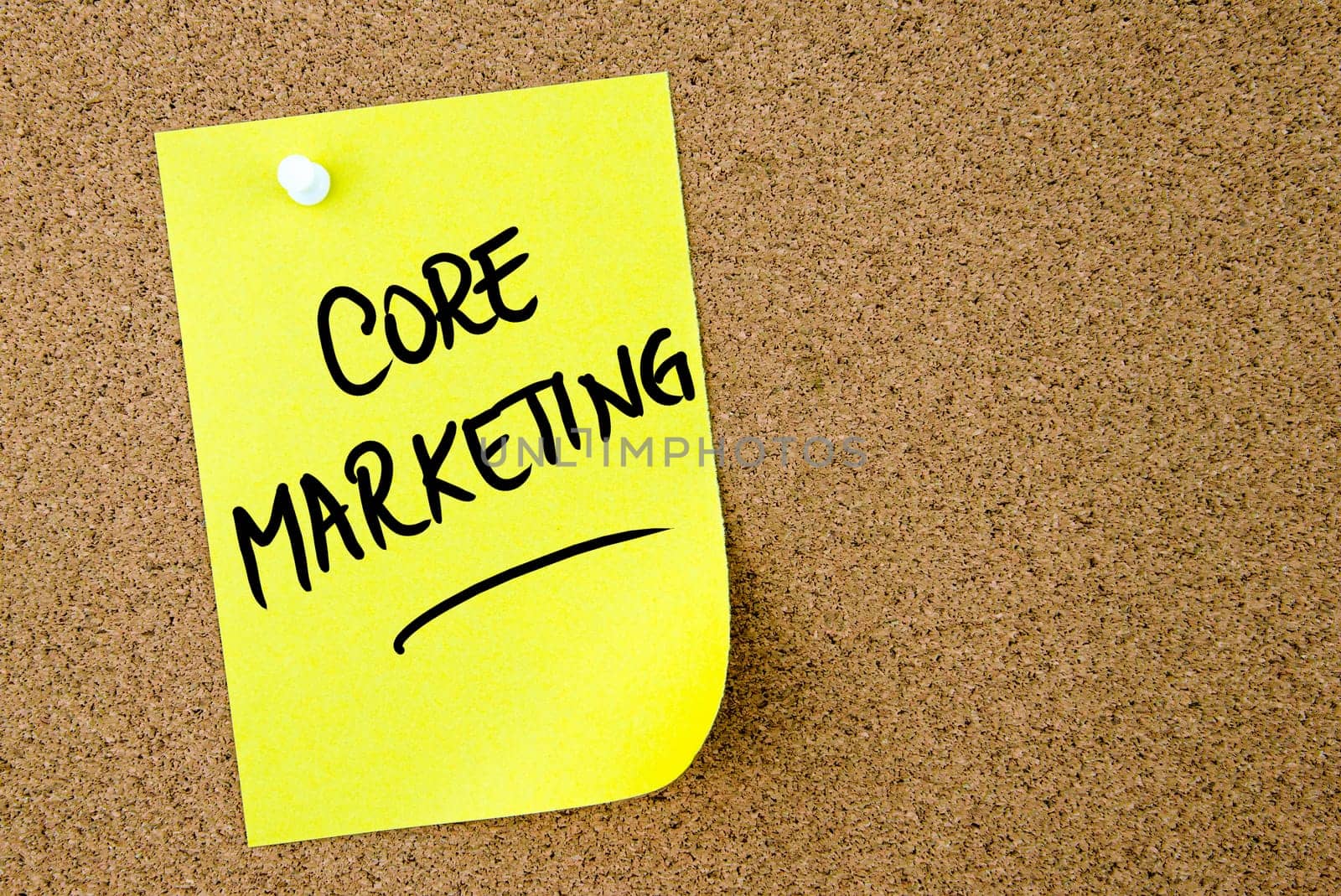 Core Marketing text written on yellow paper note pinned on cork board with white thumbtack. Business concept image with copy space available