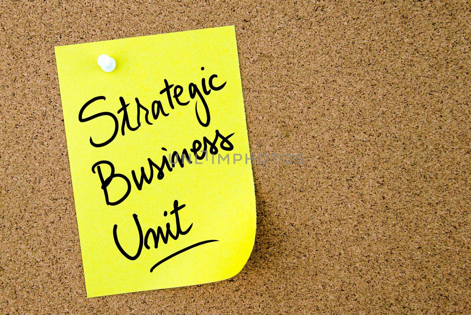 Strategic Business Unit text written on yellow paper note pinned on cork board with white thumbtack. Business concept image with copy space available