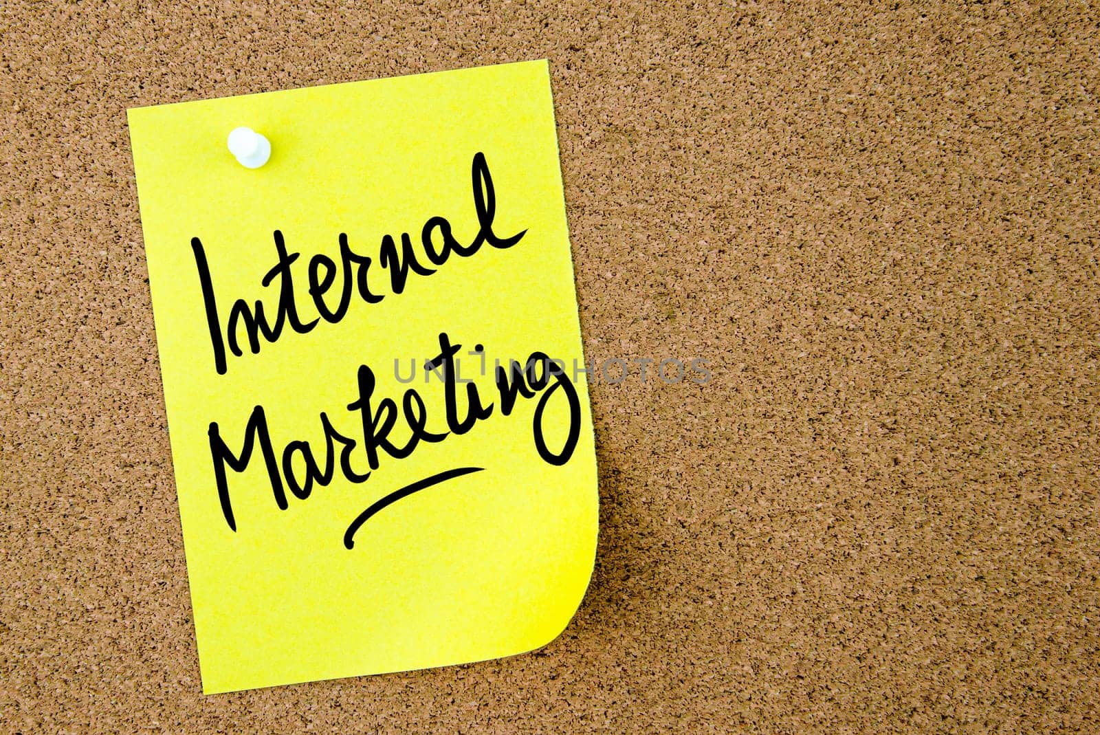 Internal Marketing text written on yellow paper note pinned on cork board with white thumbtack. Business concept image with copy space available