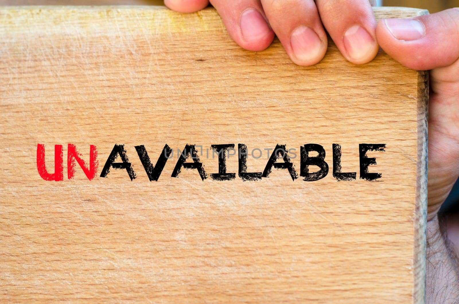 Human hand over wooden background and unavailable text concept