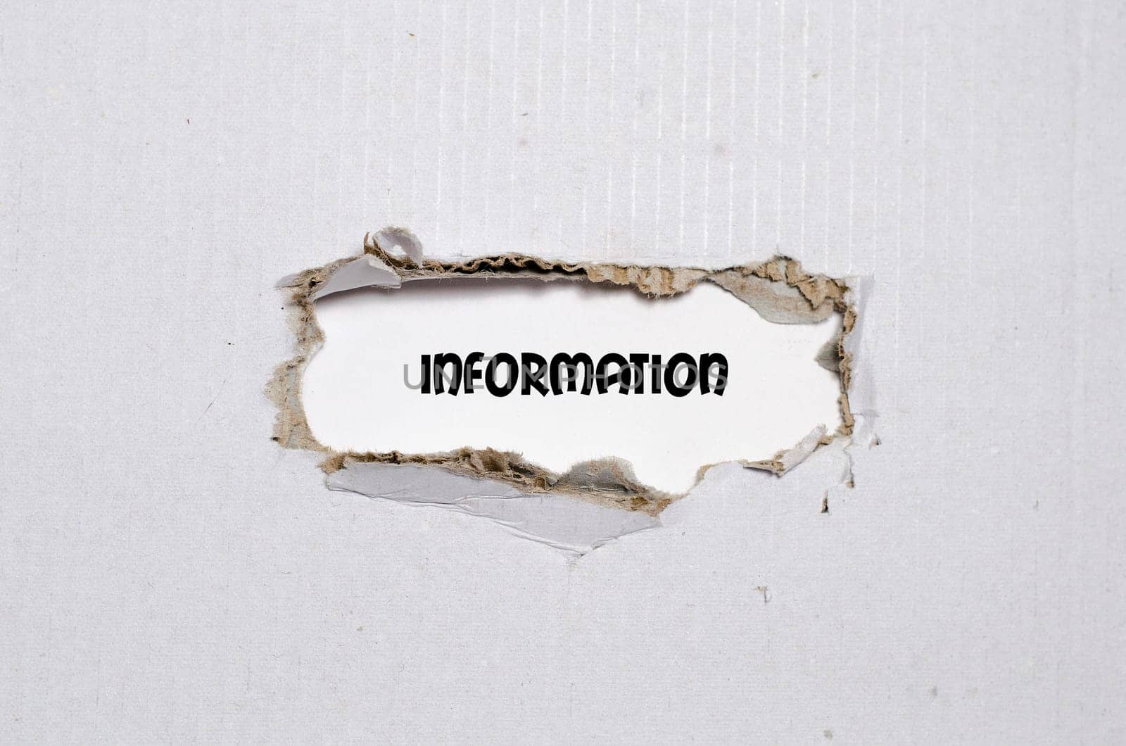 The word information appearing behind torn paper