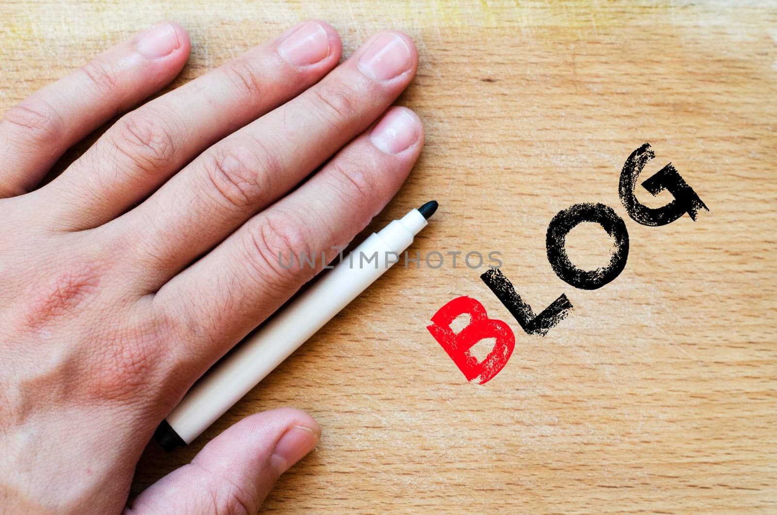 Human hand over wooden background and blog text concept