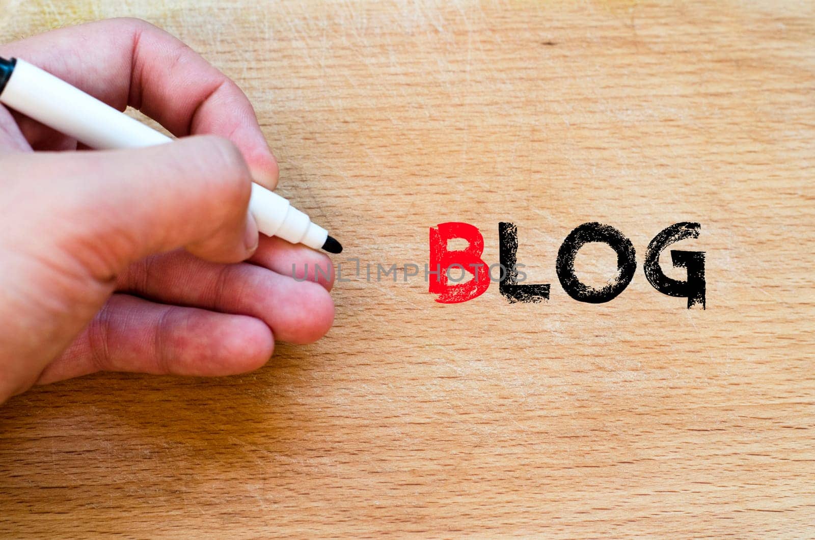 Human hand over wooden background and blog text concept