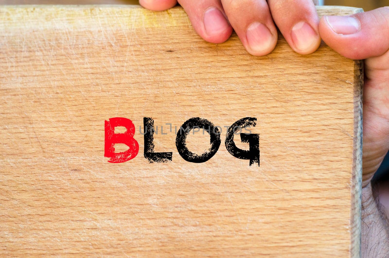 Human hand over wooden background and blog text concept
