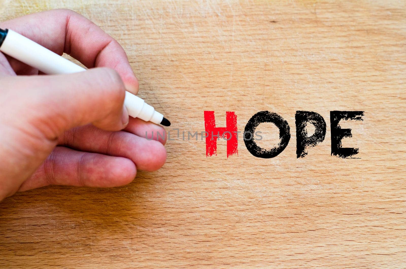 Human hand over wooden background and hope text concept