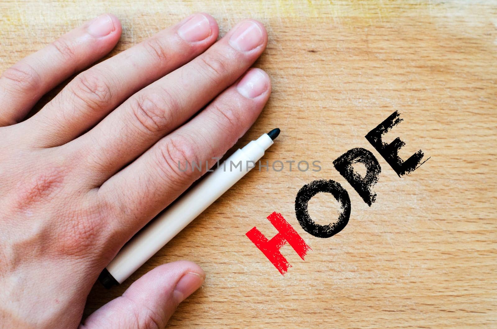 Human hand over wooden background and hope text concept