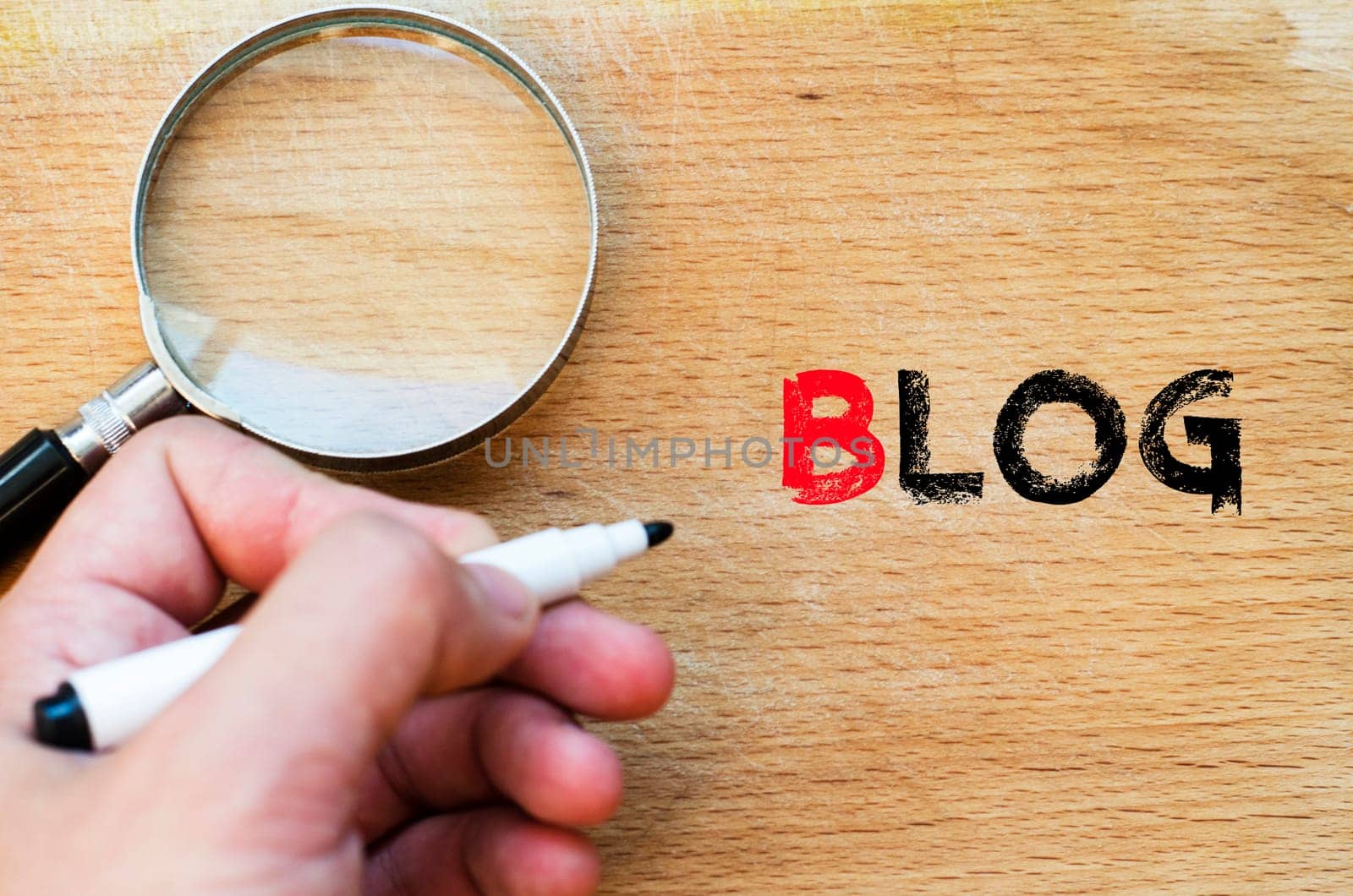 Human hand over wooden background and blog text concept