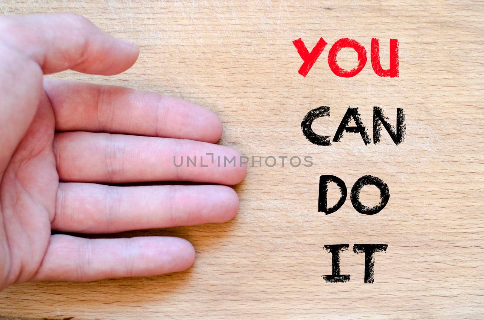 Human hand over wooden background and you can do it text concept