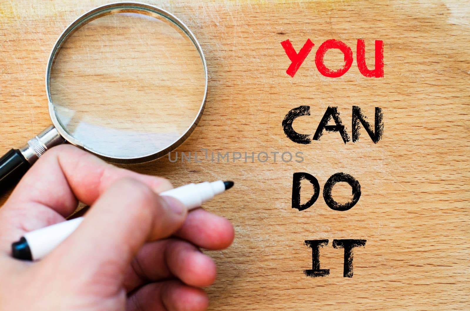 Human hand over wooden background and you can do it text concept