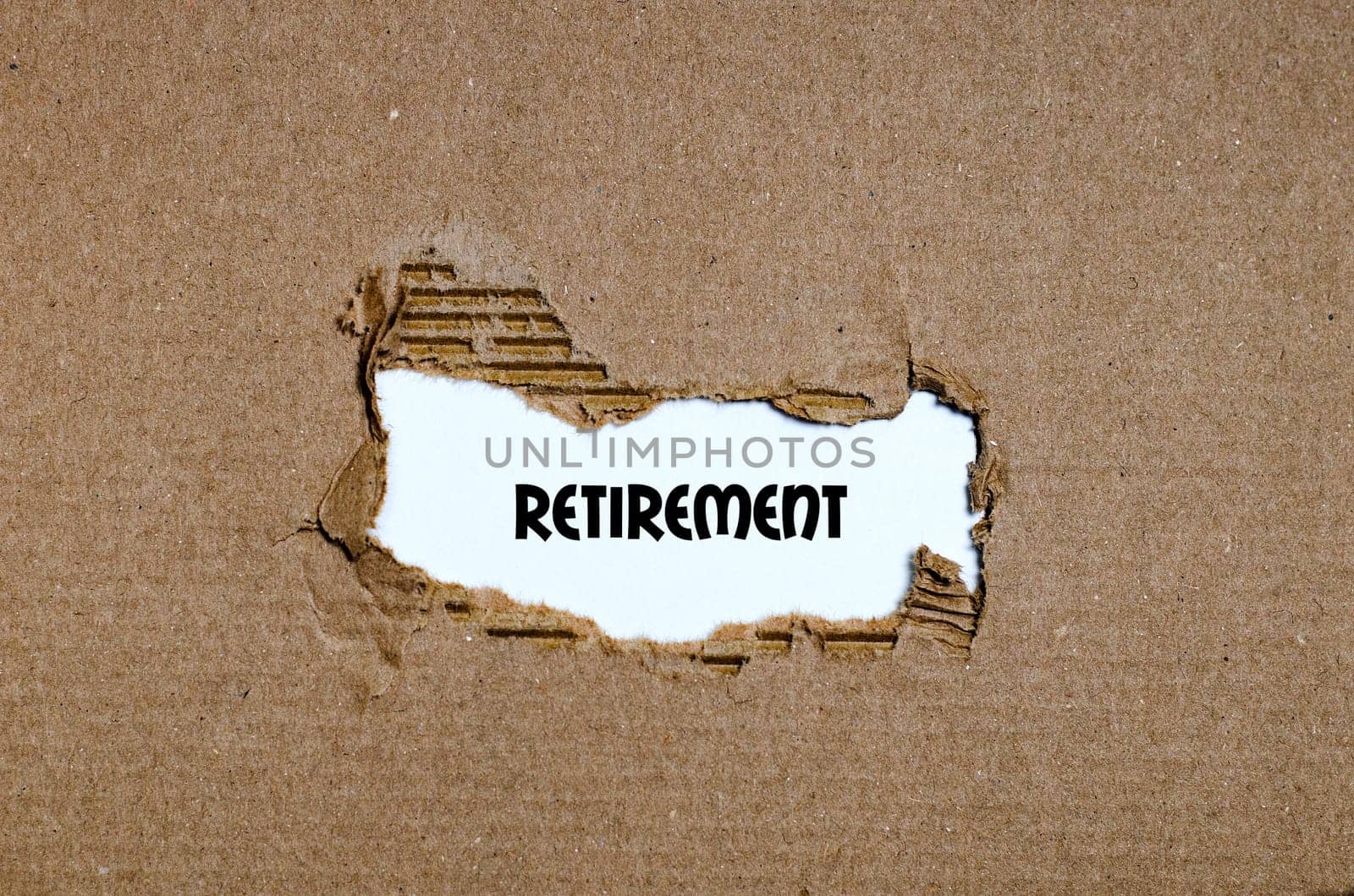The word retirement appearing behind torn paper