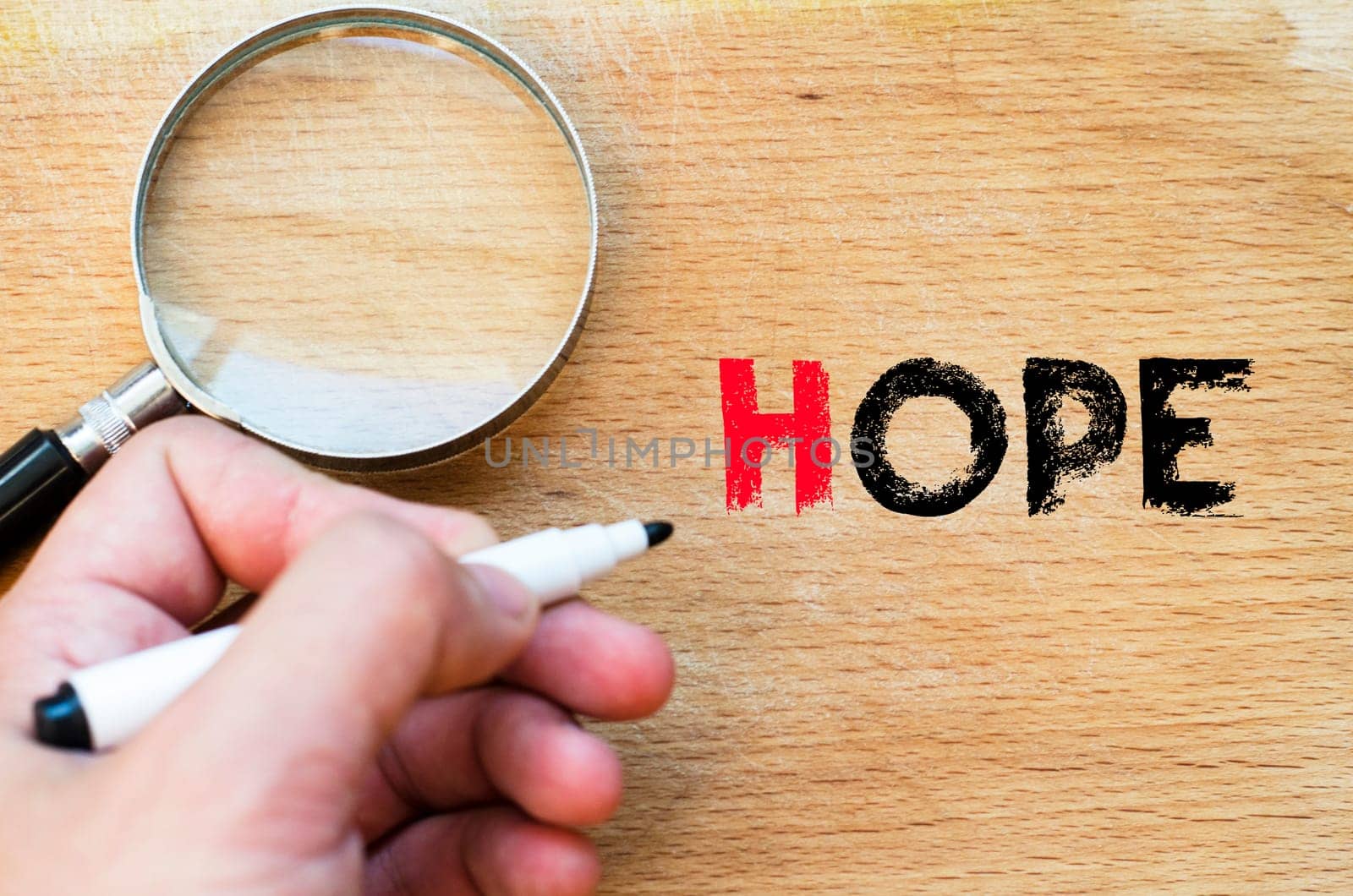 Human hand over wooden background and hope text concept