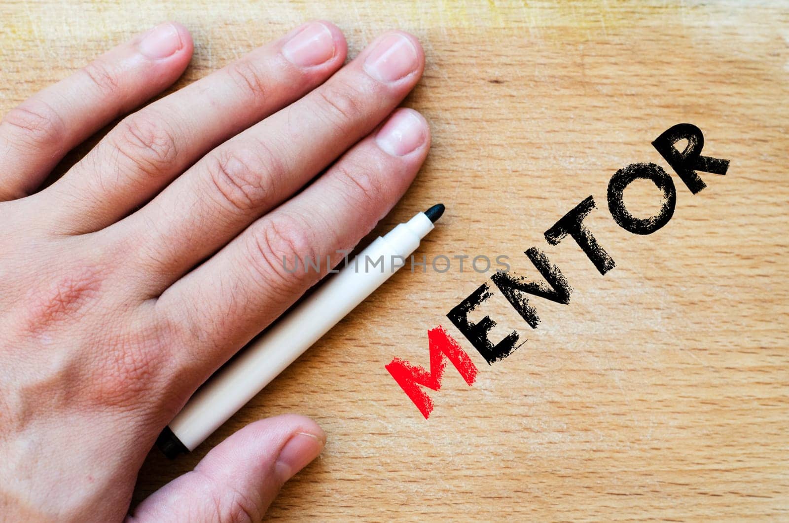 Human hand over wooden background and mentor text concept