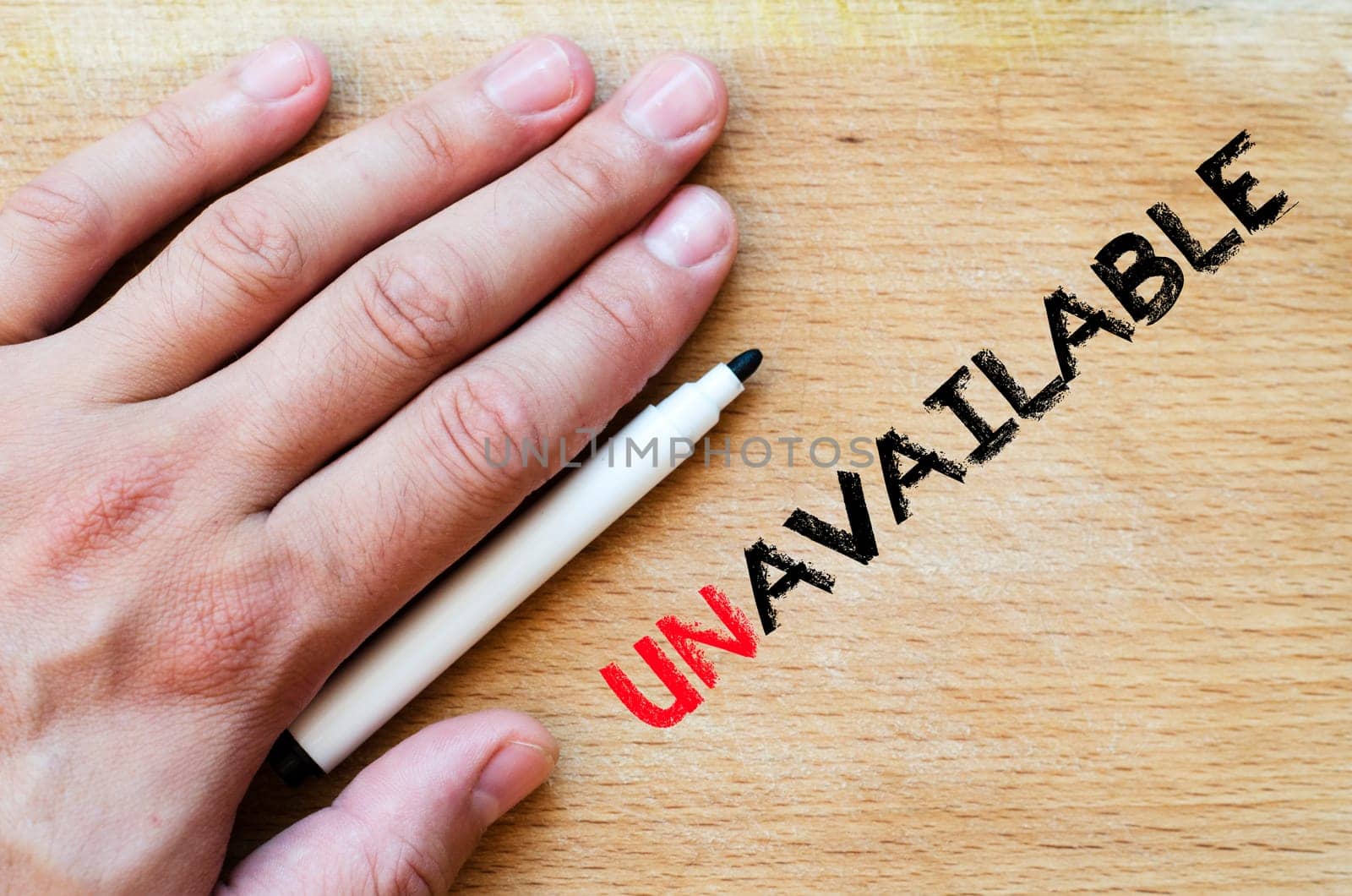 Human hand over wooden background and unavailable text concept