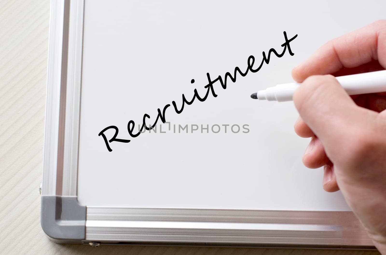 Human hand writing recruitment on whiteboard