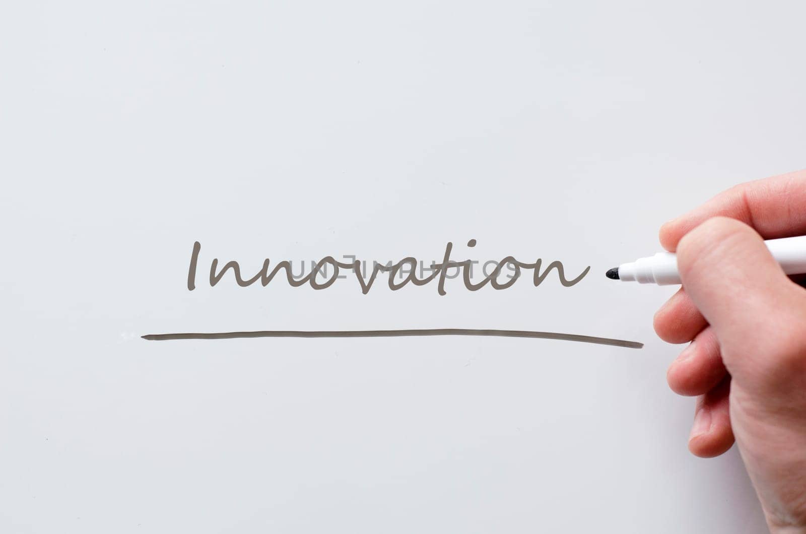 Human hand writing innovation on whiteboard