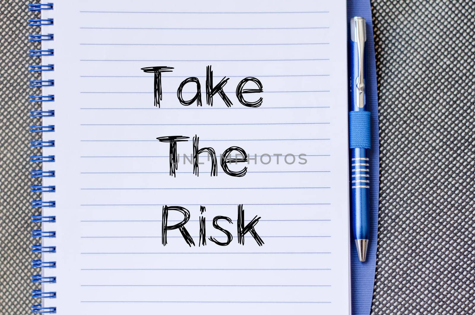 Take the risk text concept write on notebook