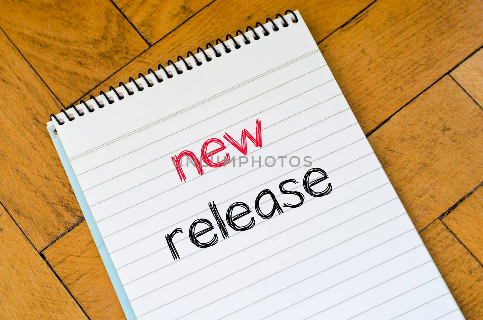 White notepad and human hand on the wooden background