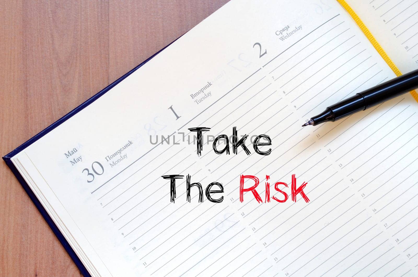 Take the risk text concept write on notebook