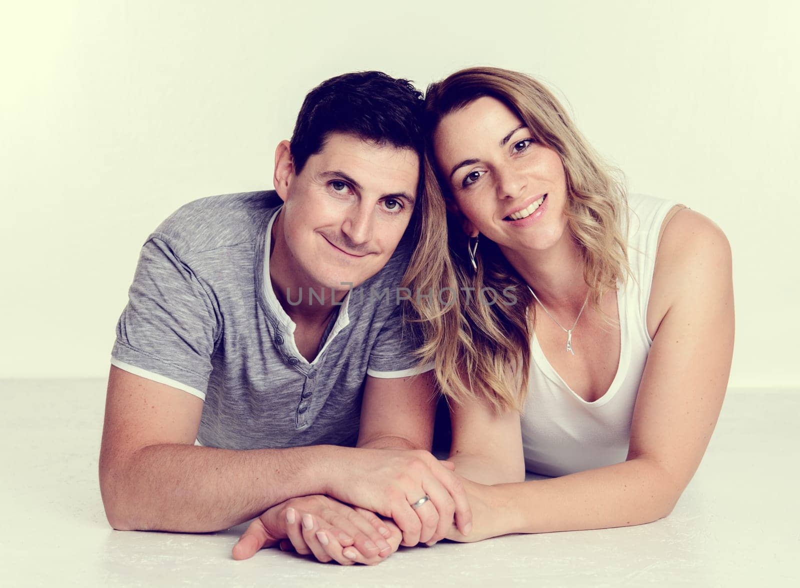 young beautiful couple in front of bright background