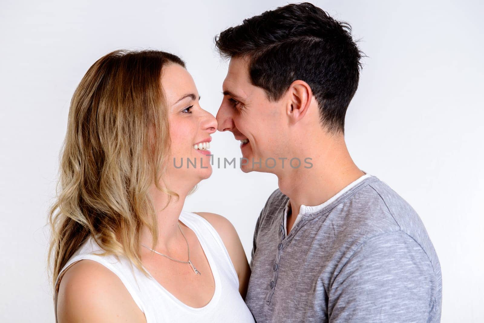 young beautiful couple in front of white background