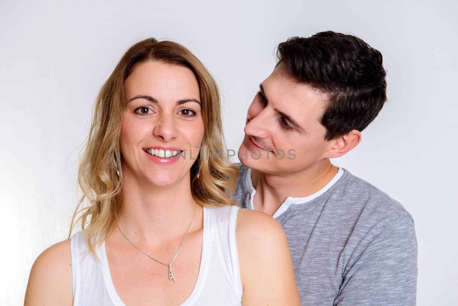 young beautiful couple in front of white background