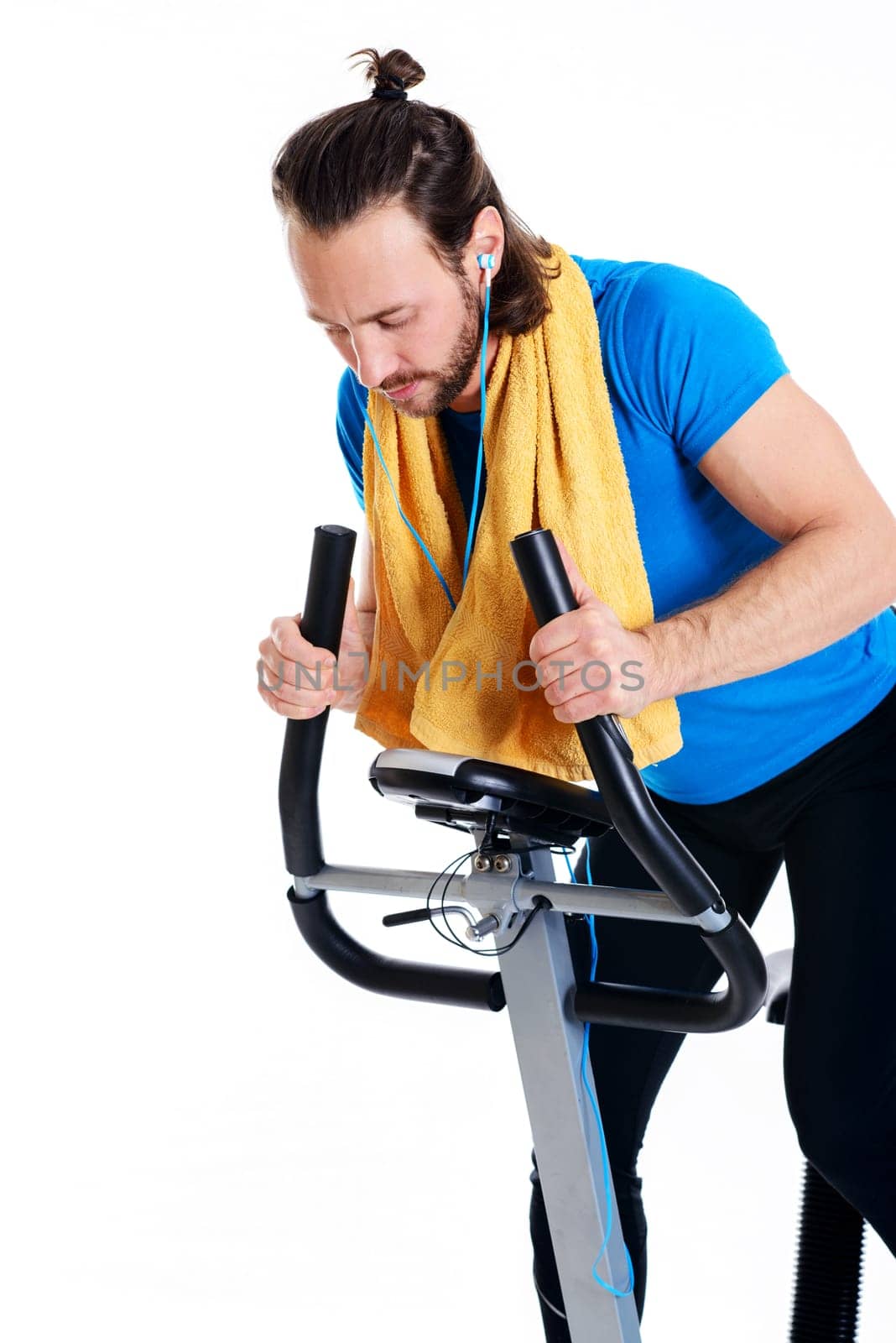 young man in blue shirt train with fitness machine and listening music