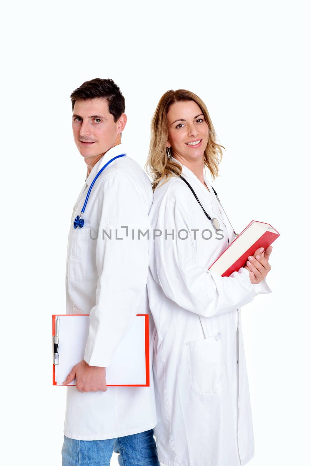 young friendly medical team with book in lab coat in front of white background