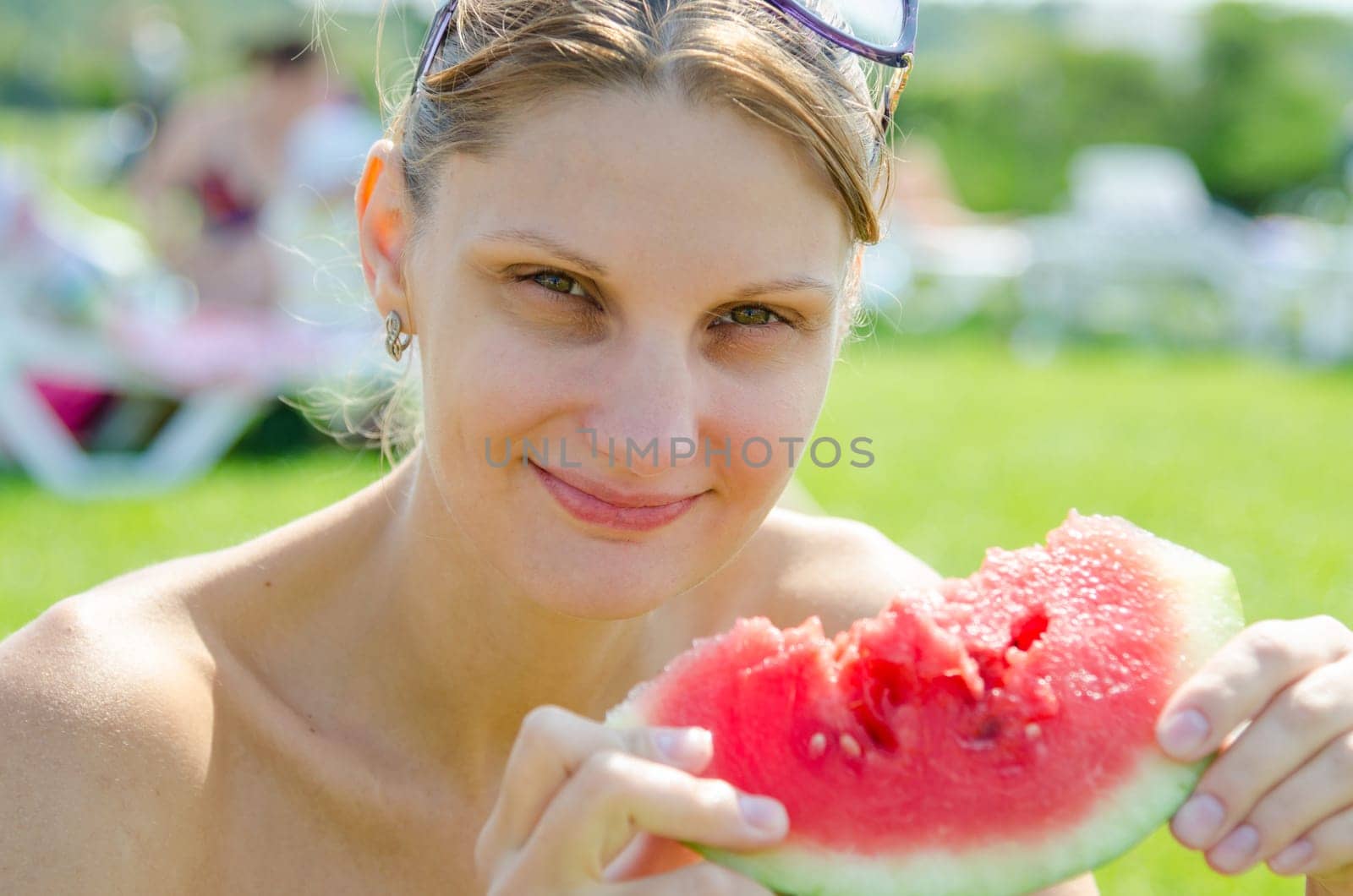 Young girl eating watermelon, close up portrait