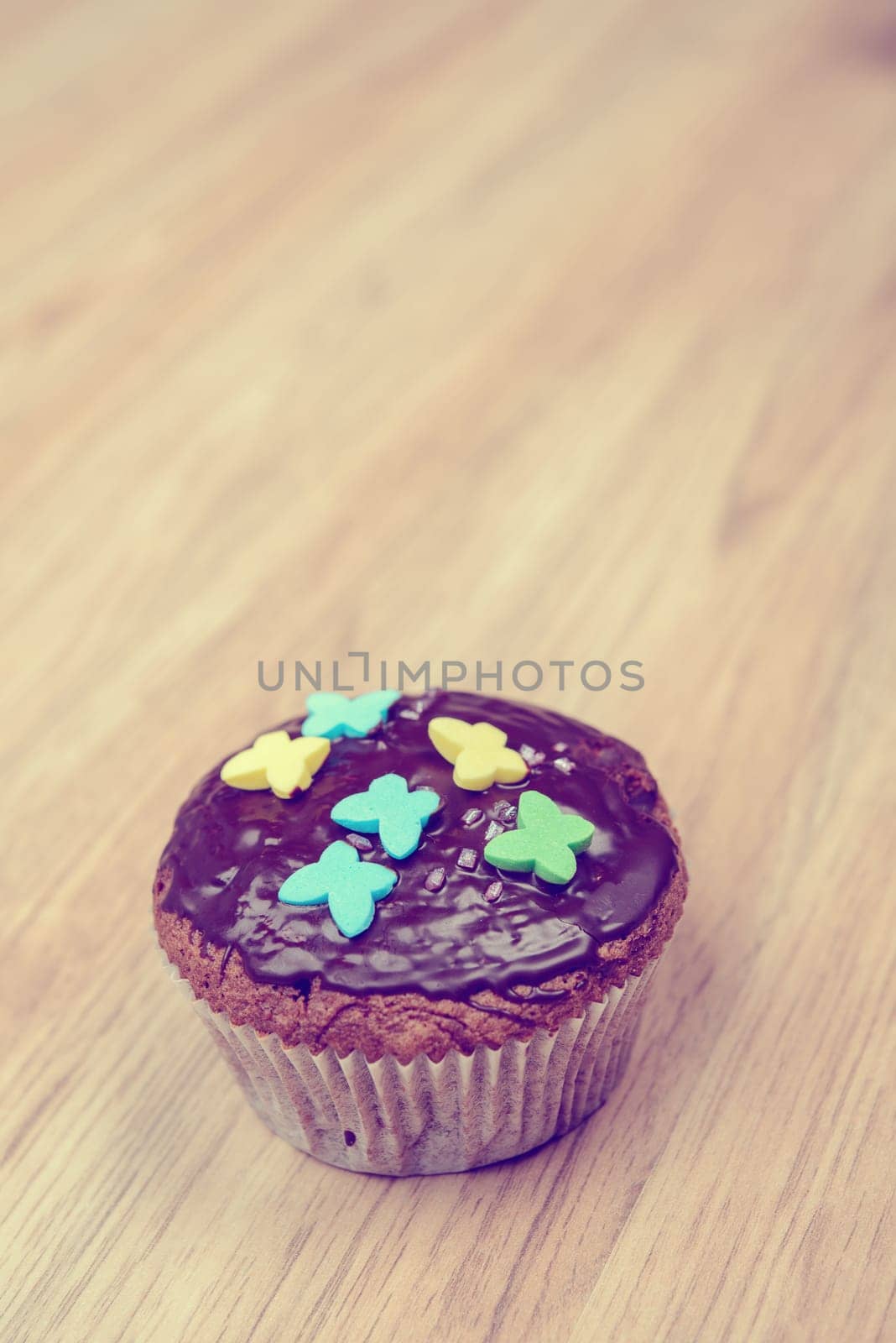 chocolate muffin with in vintage look on wooden ground
