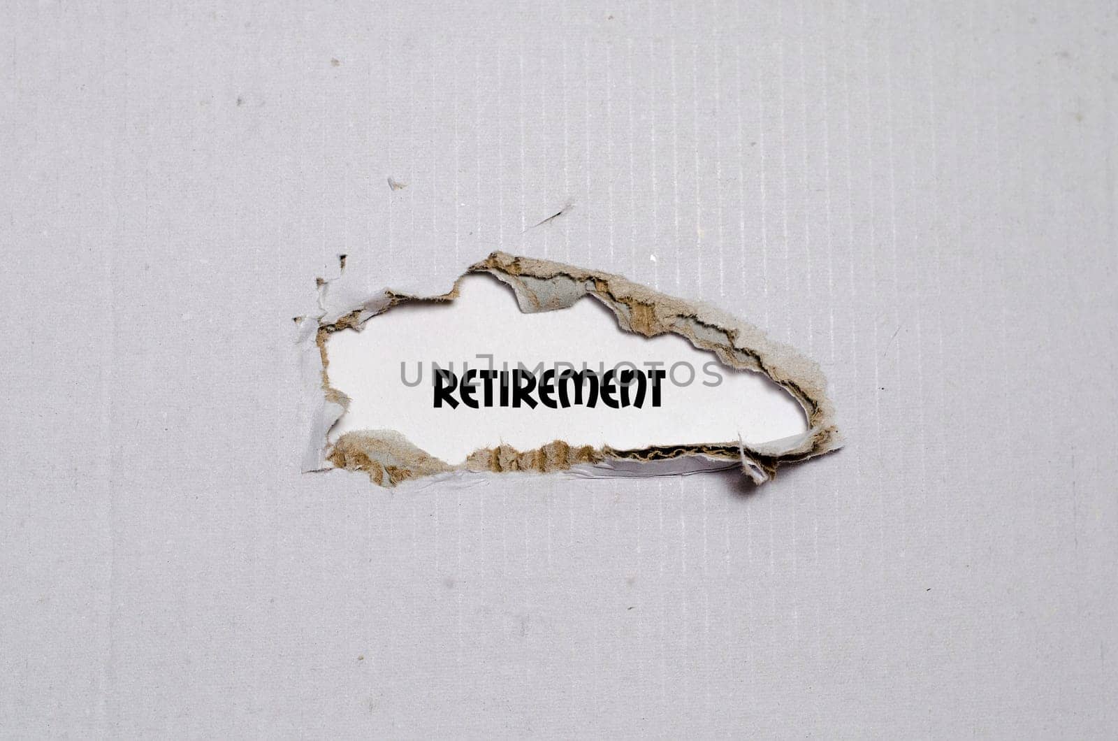 The word retirement appearing behind torn paper