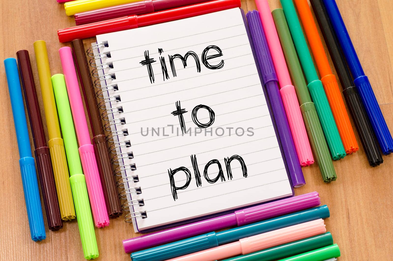 Felt-tip pen and notepad on a wooden background and time to plan text concept