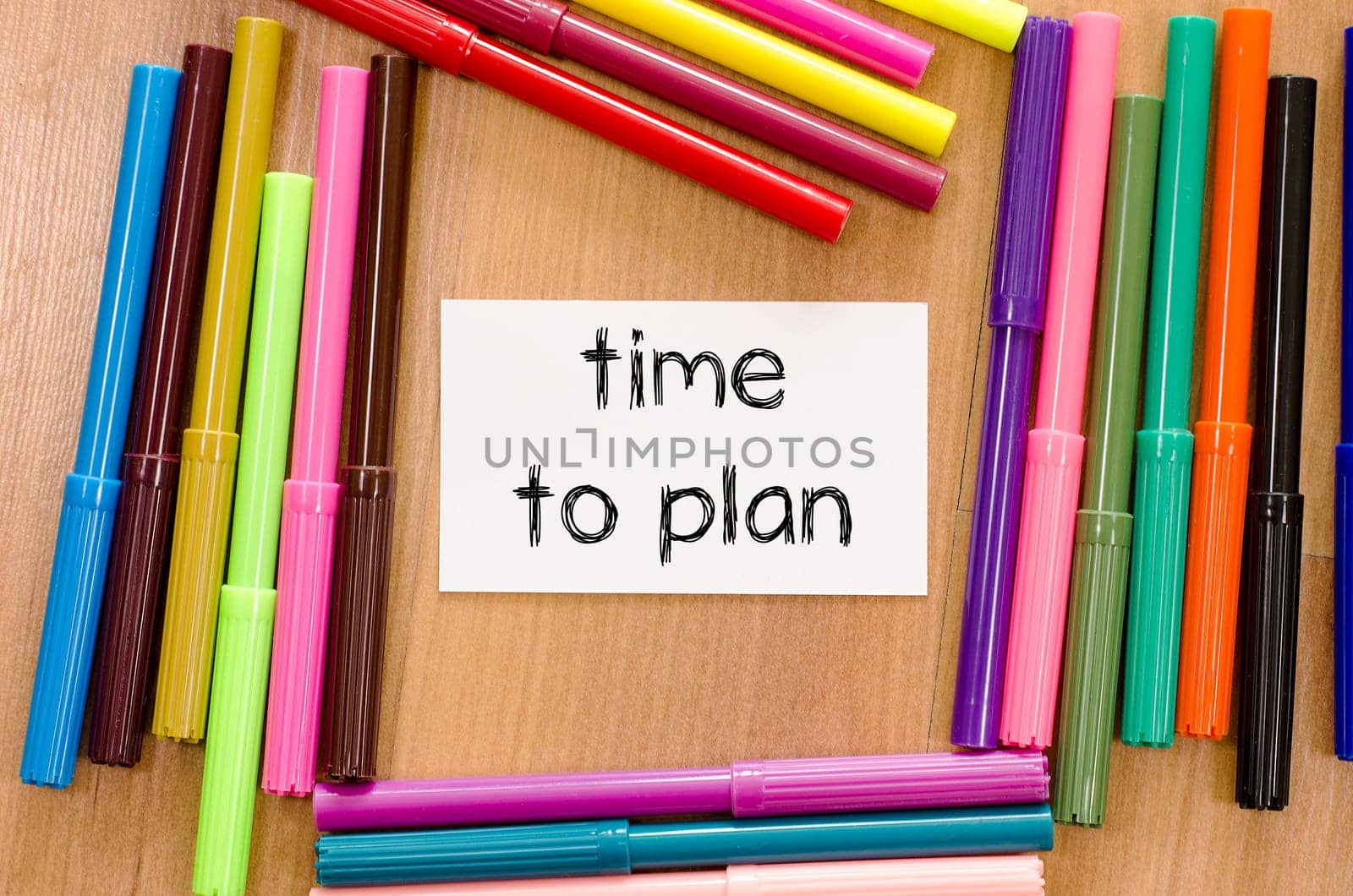 Felt-tip pen and note on a wooden background and time to plan text concept