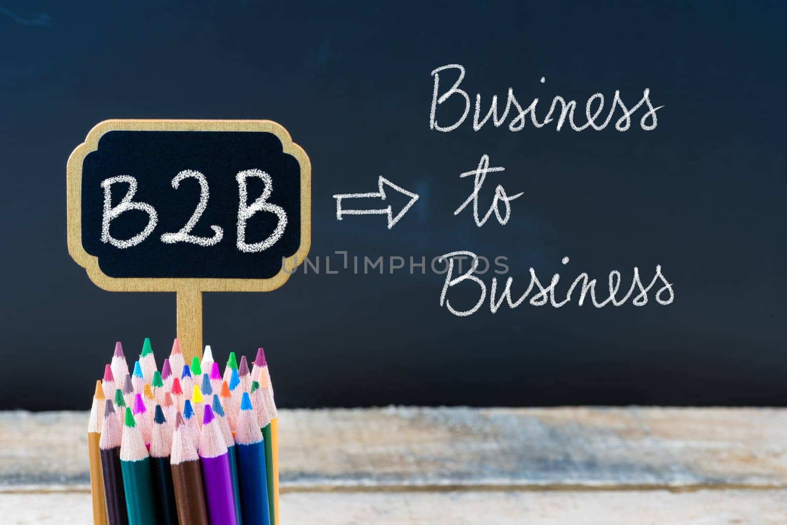 Business Acronym B2B Business To Business written with chalk on wooden mini blackboard labels and chalkboard background.